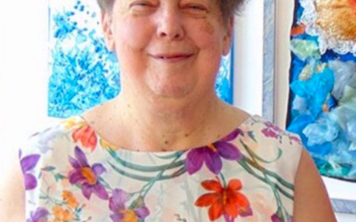 Woman wearing a colourful floral blouse Woman wearing a colourful floral blouse.