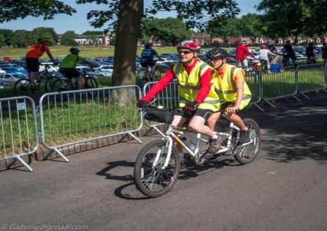 Two men on a tandem Cycle.