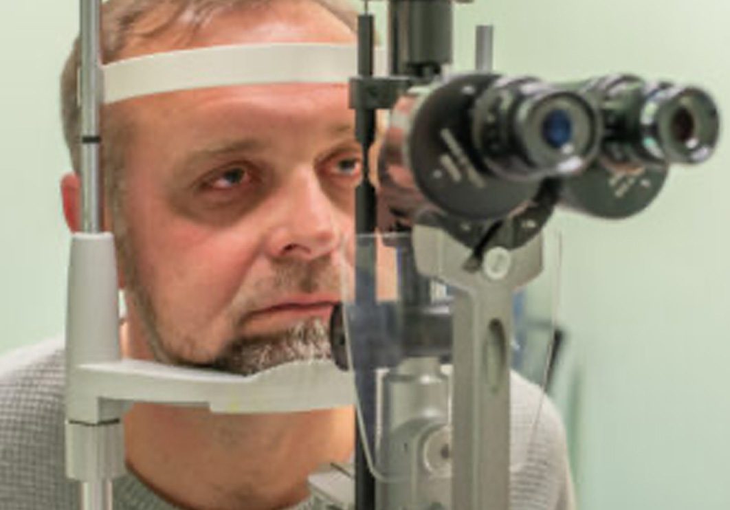 Man having his eyes tested with special equipment.