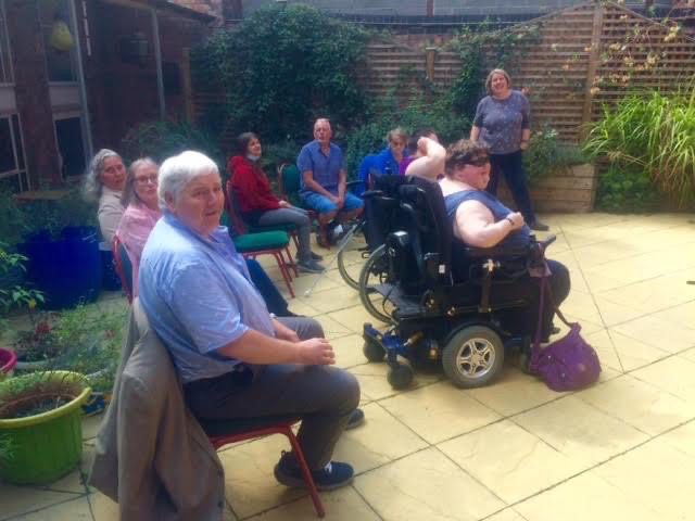 My Sight Choir seated in a garden.