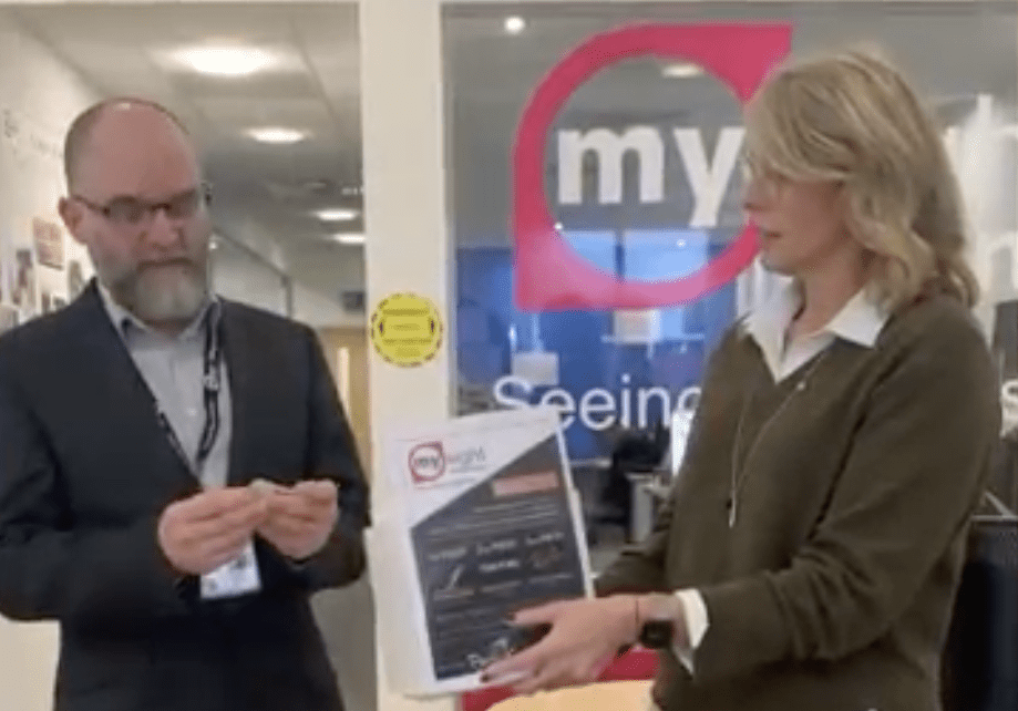 A man and a woman. The man is choosing a winning raffle ticket.