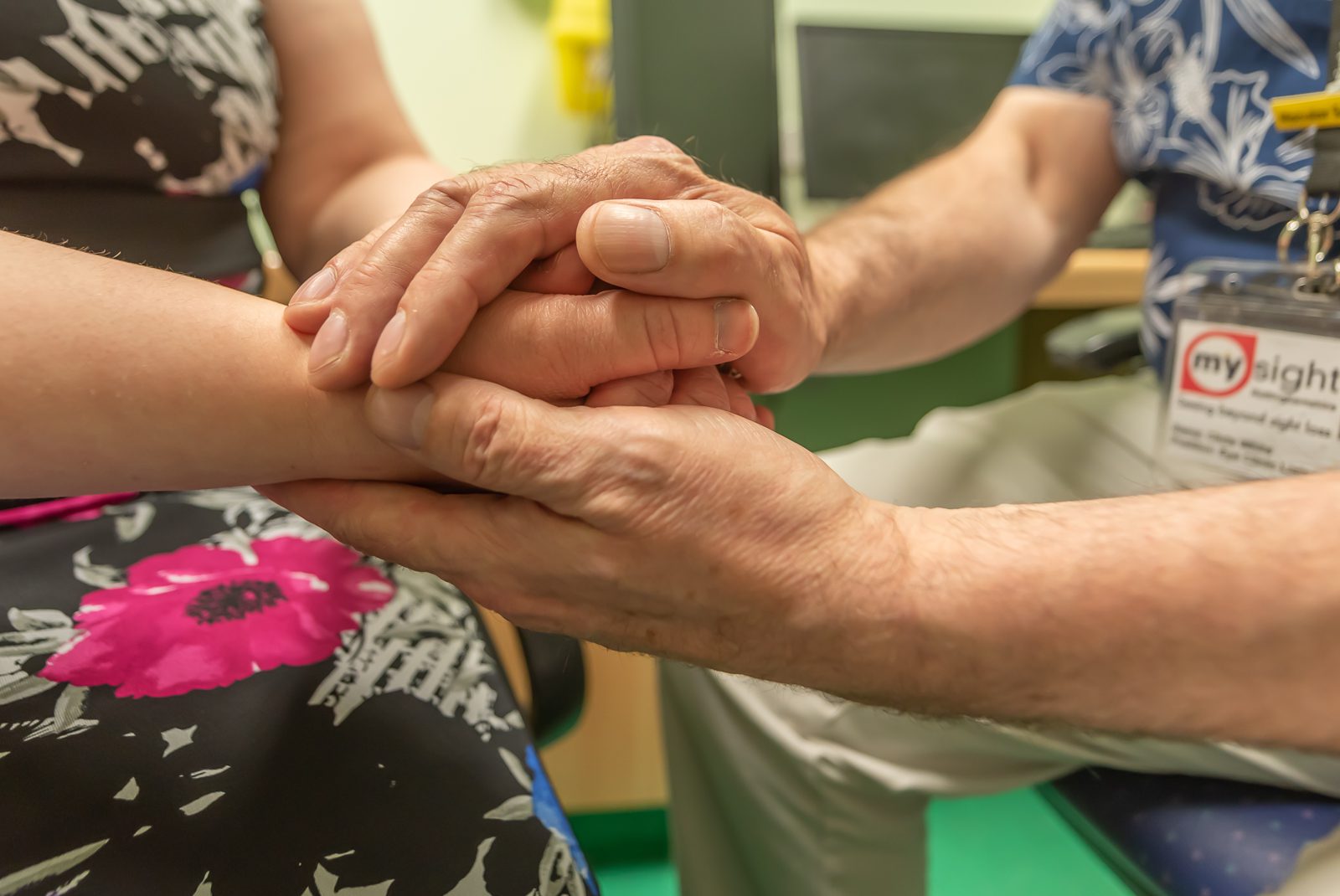 Eye Clinic Liaison Officer ECLO talking to a woman.leaflet.